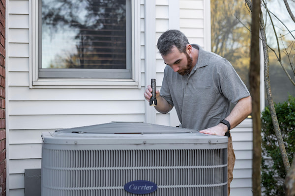 maintenance tech servicing air conditioning